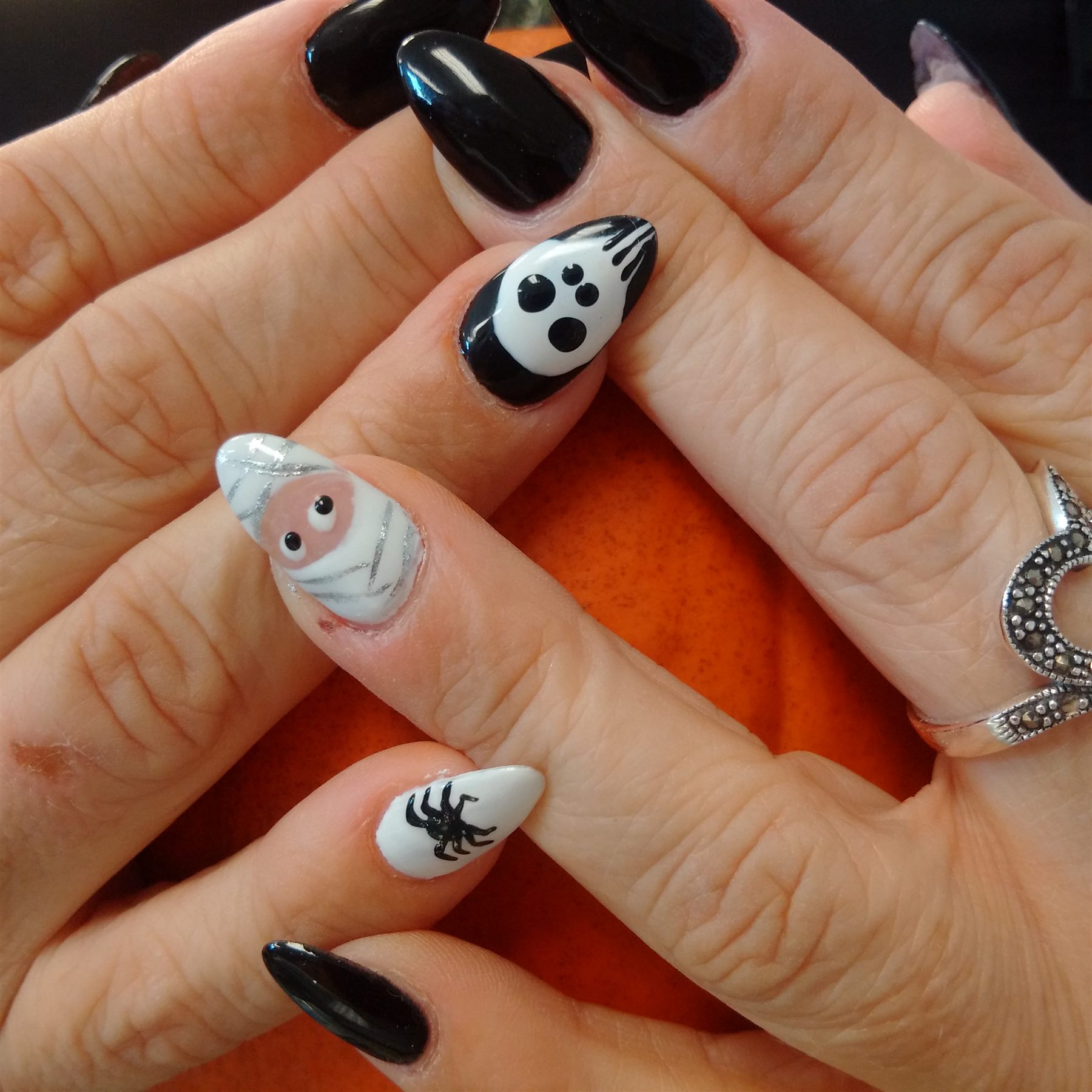 Black and white Halloween nails with ghost, mummy and spider art
