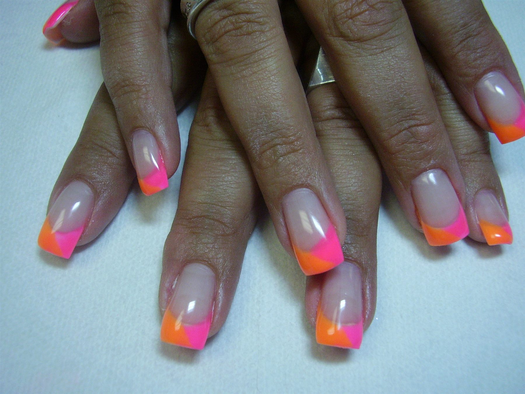 Neon pink and orange colour-block French nails