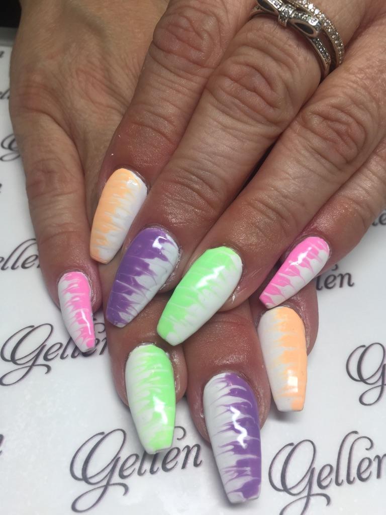 Long pastel neon nails with white zebra-pattern accents