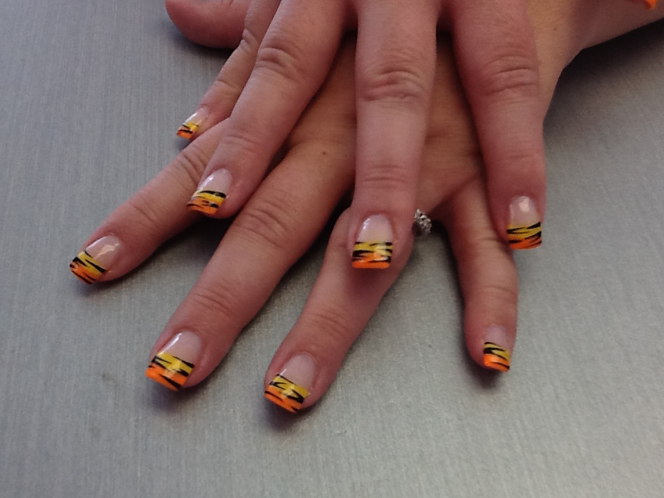 Orange and yellow French nails with black tiger stripes