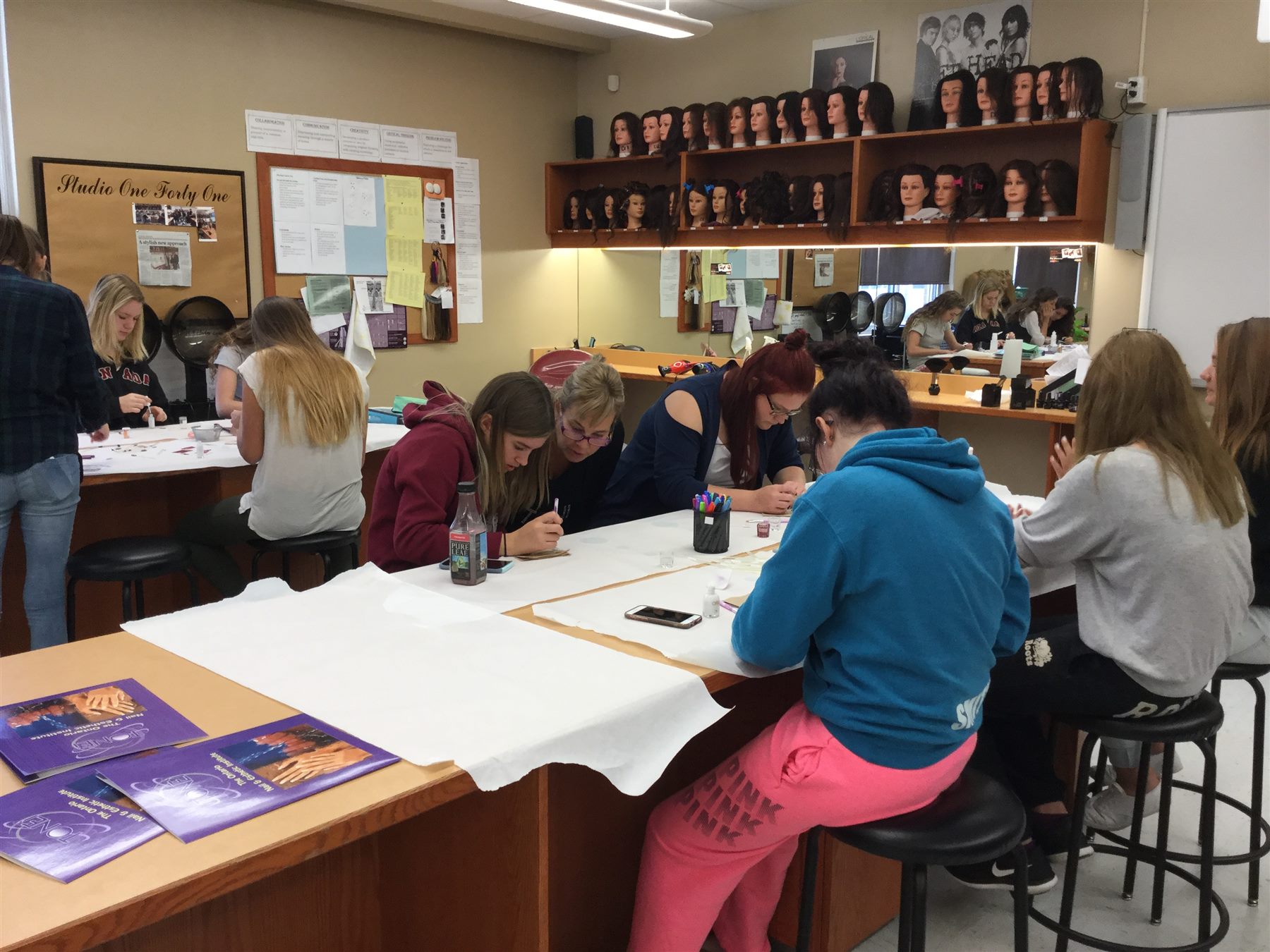 High school students participating in a hands-on nail demonstration workshop
