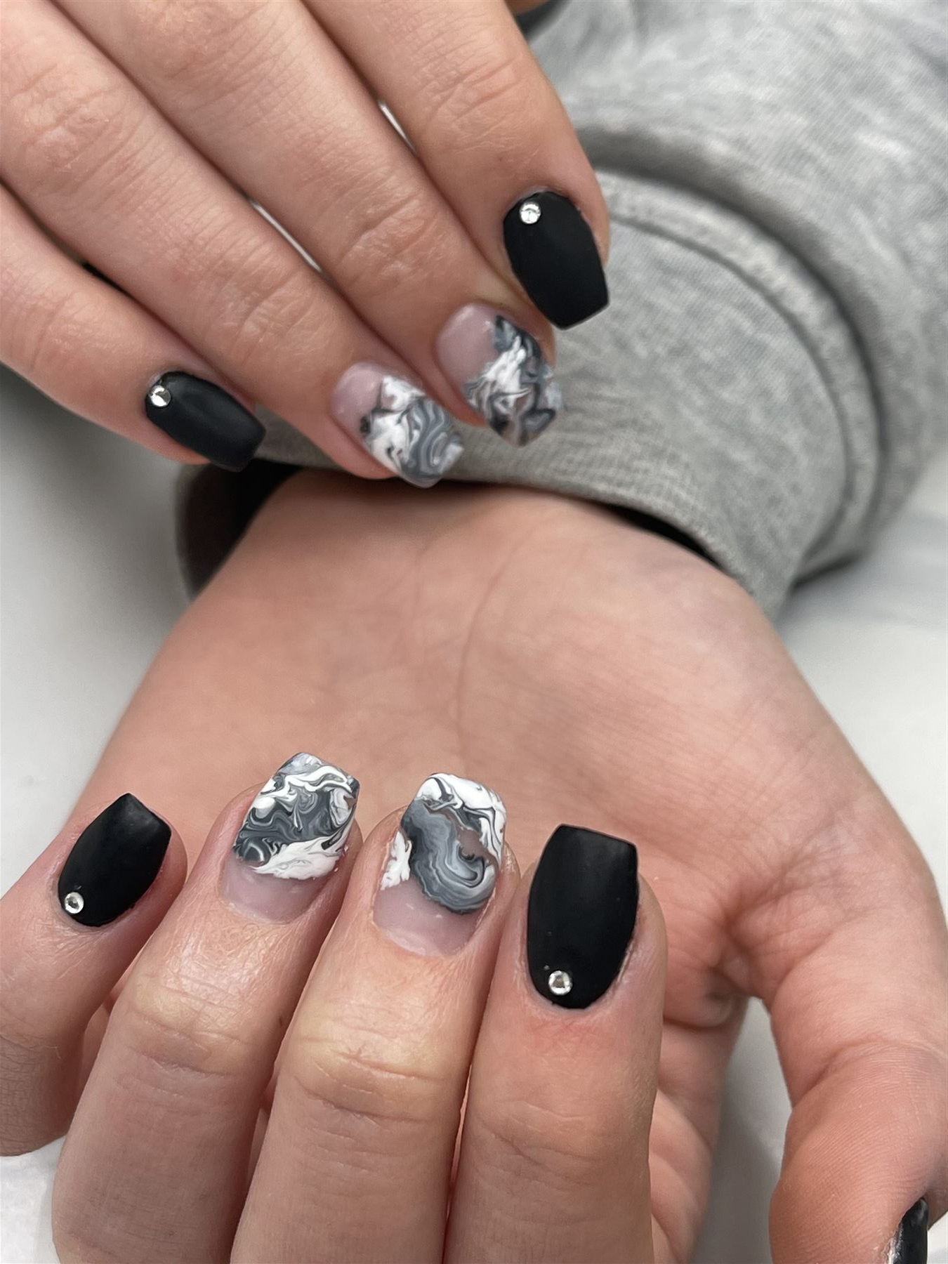 Matte black nails with black, white and grey marble accents