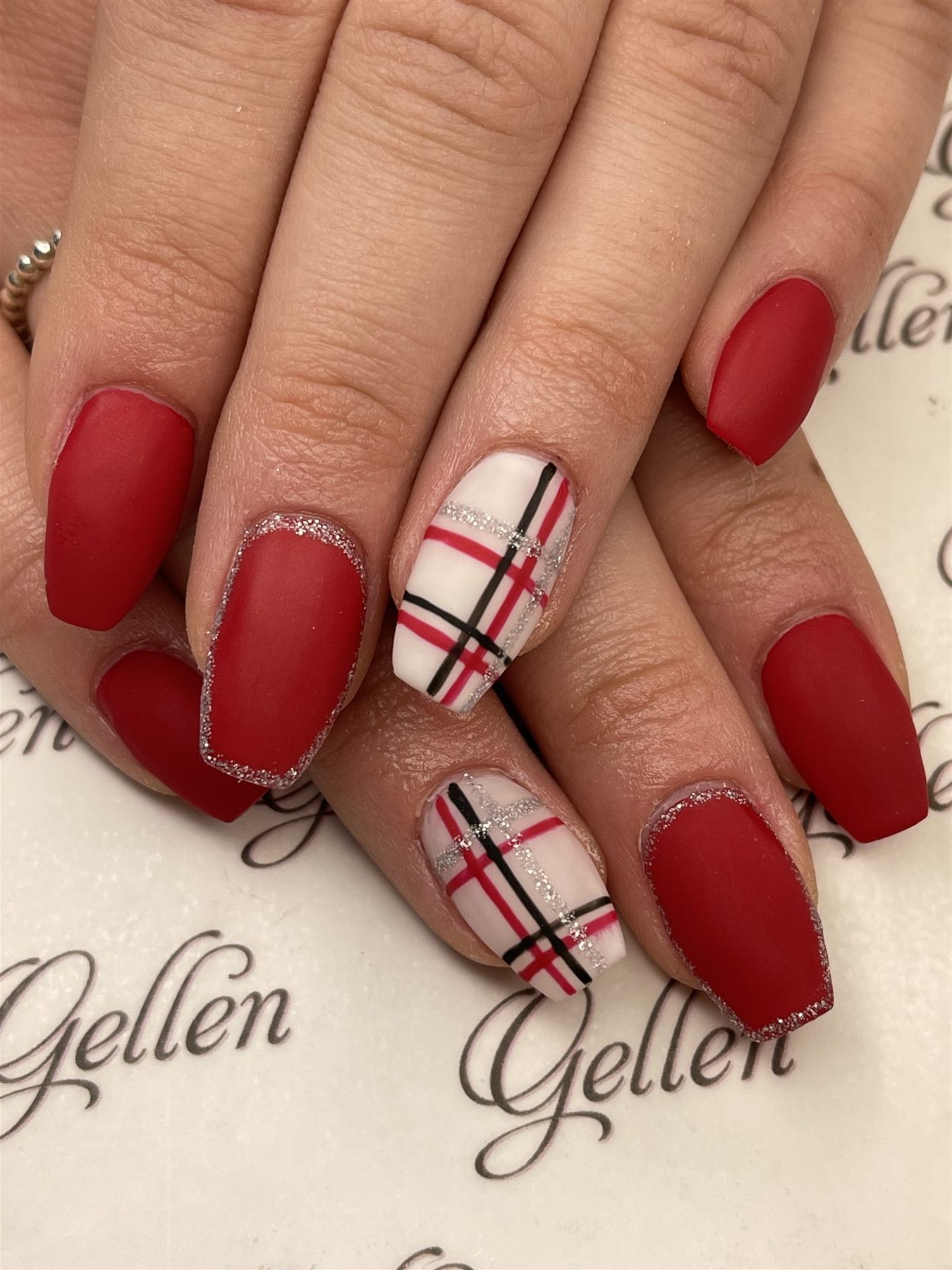 Matte red nails with plaid black silver and white accents