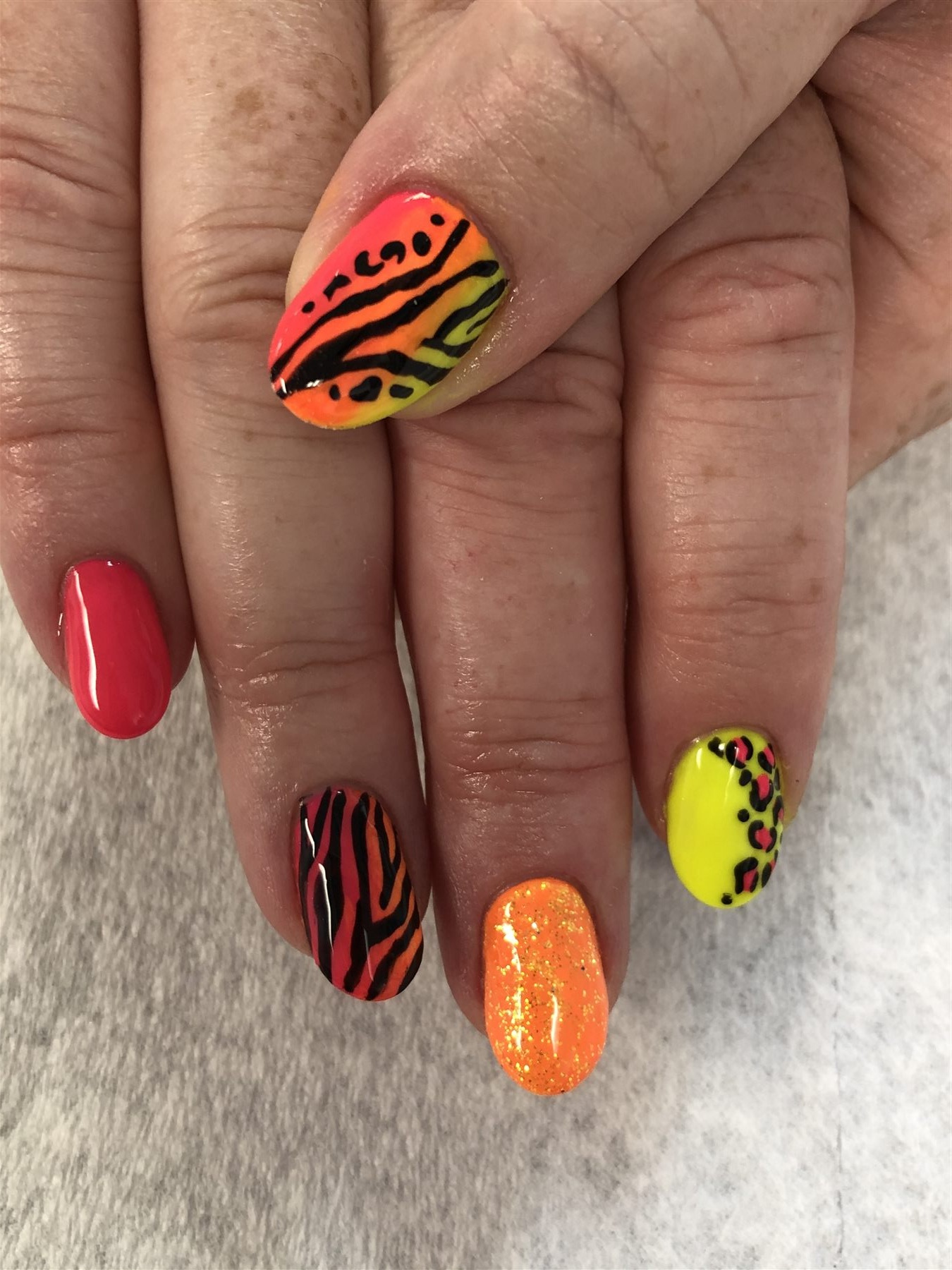 Neon pink orange and yellow animal print nails