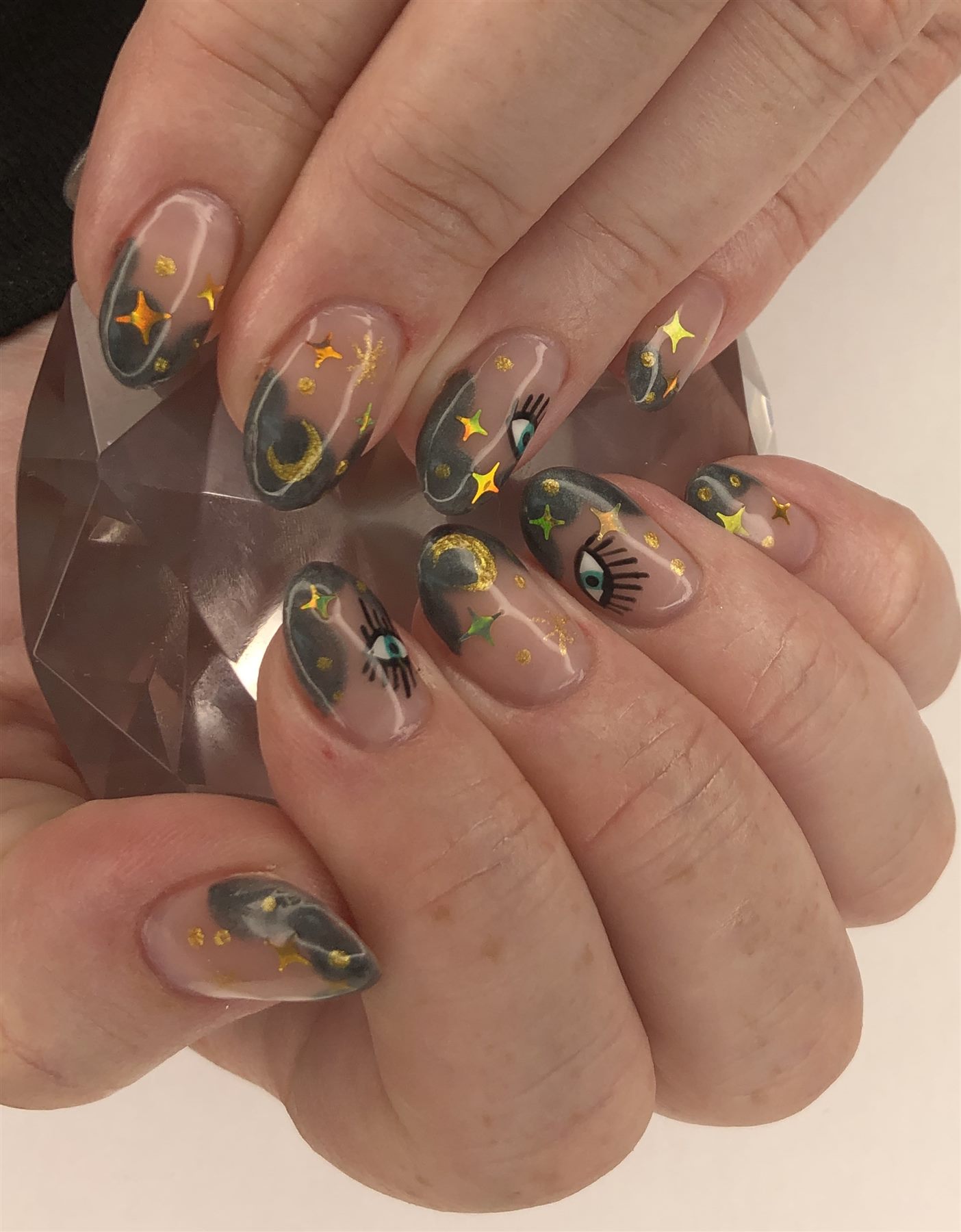 Grey celestial nails with gold stars moons and eye art
