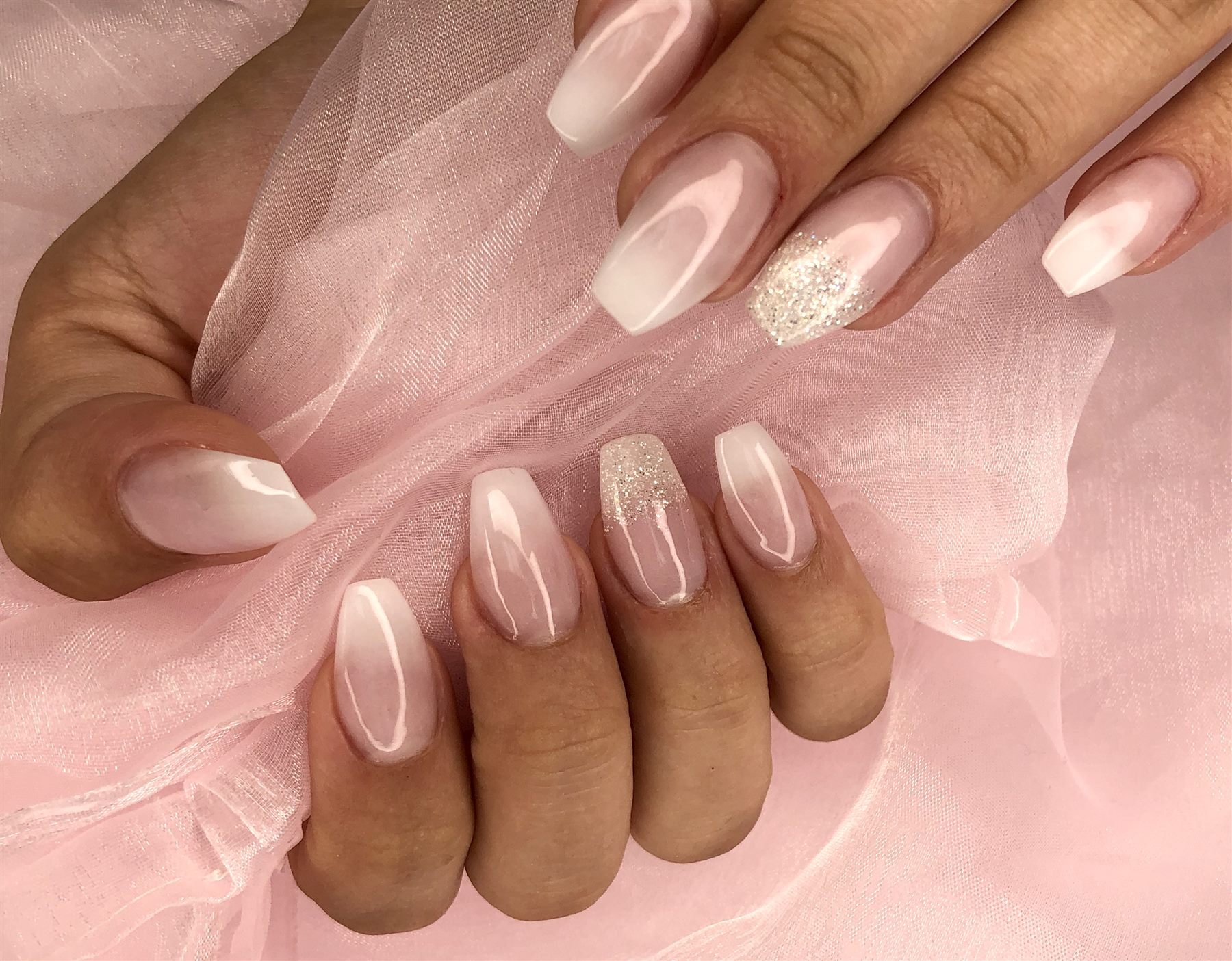 Blush ombre French nails with silver glitter accents