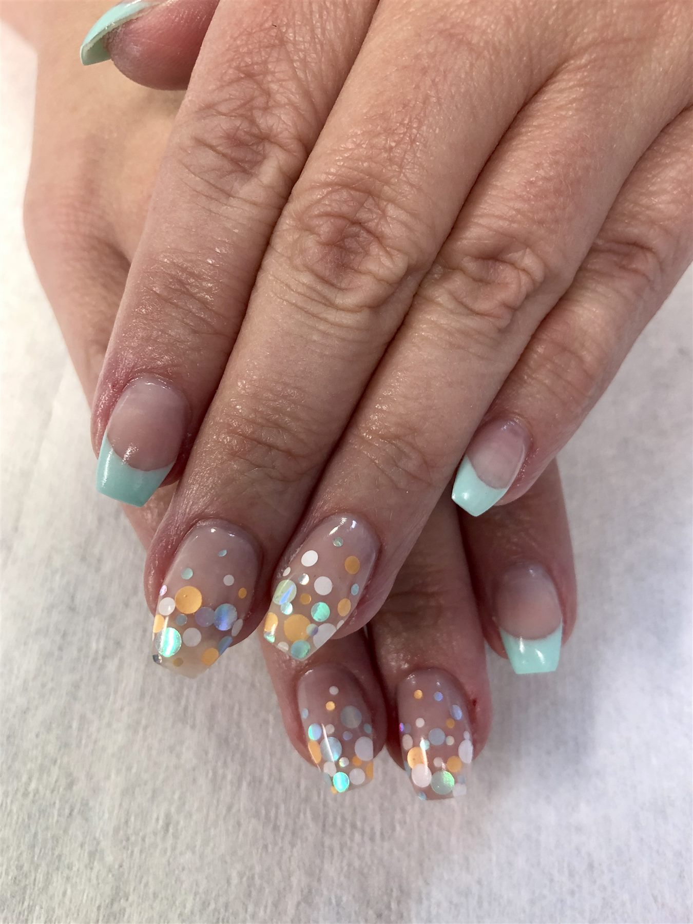 Mint French nails with pastel confetti accents