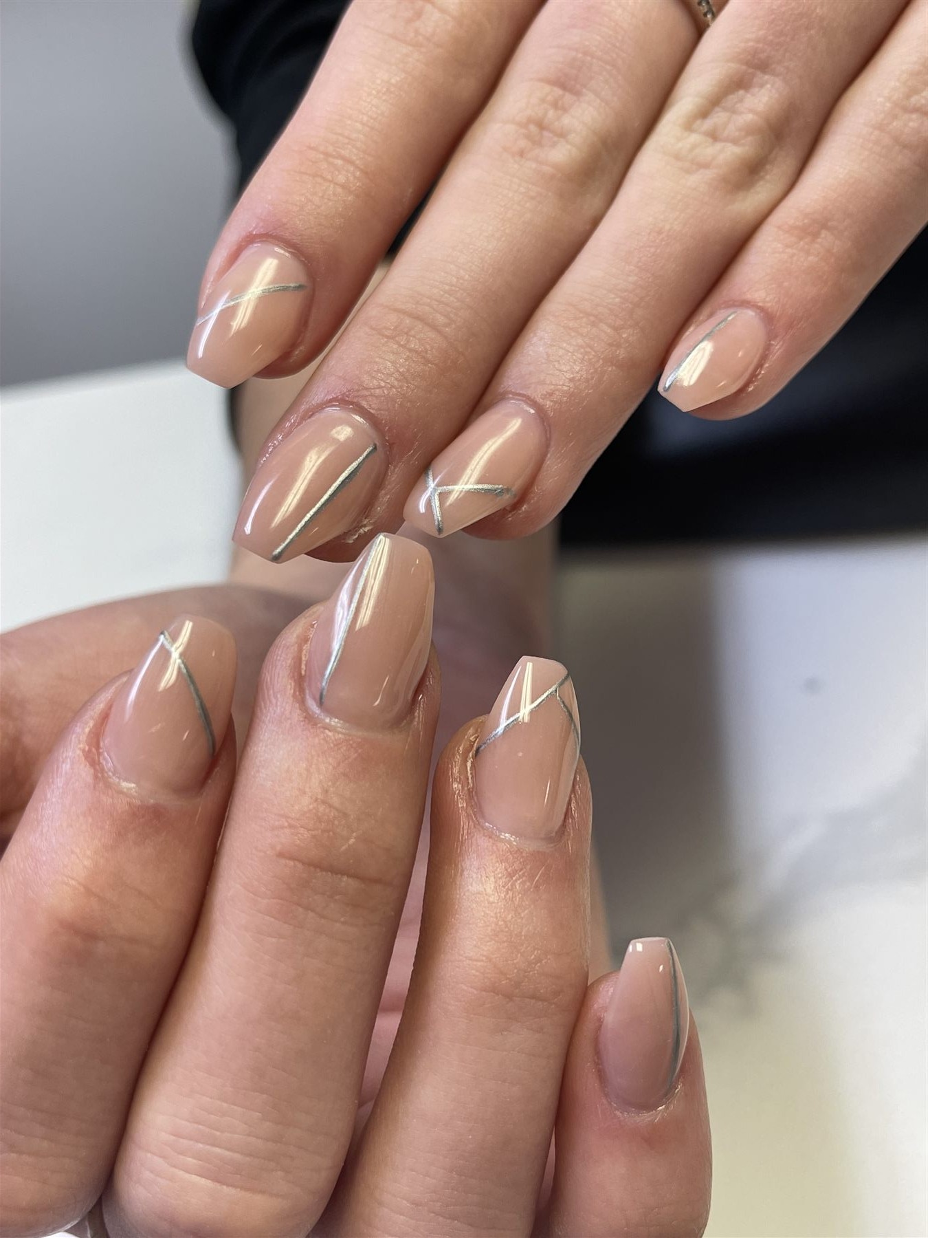 Glossy nude nails with minimalist silver line art