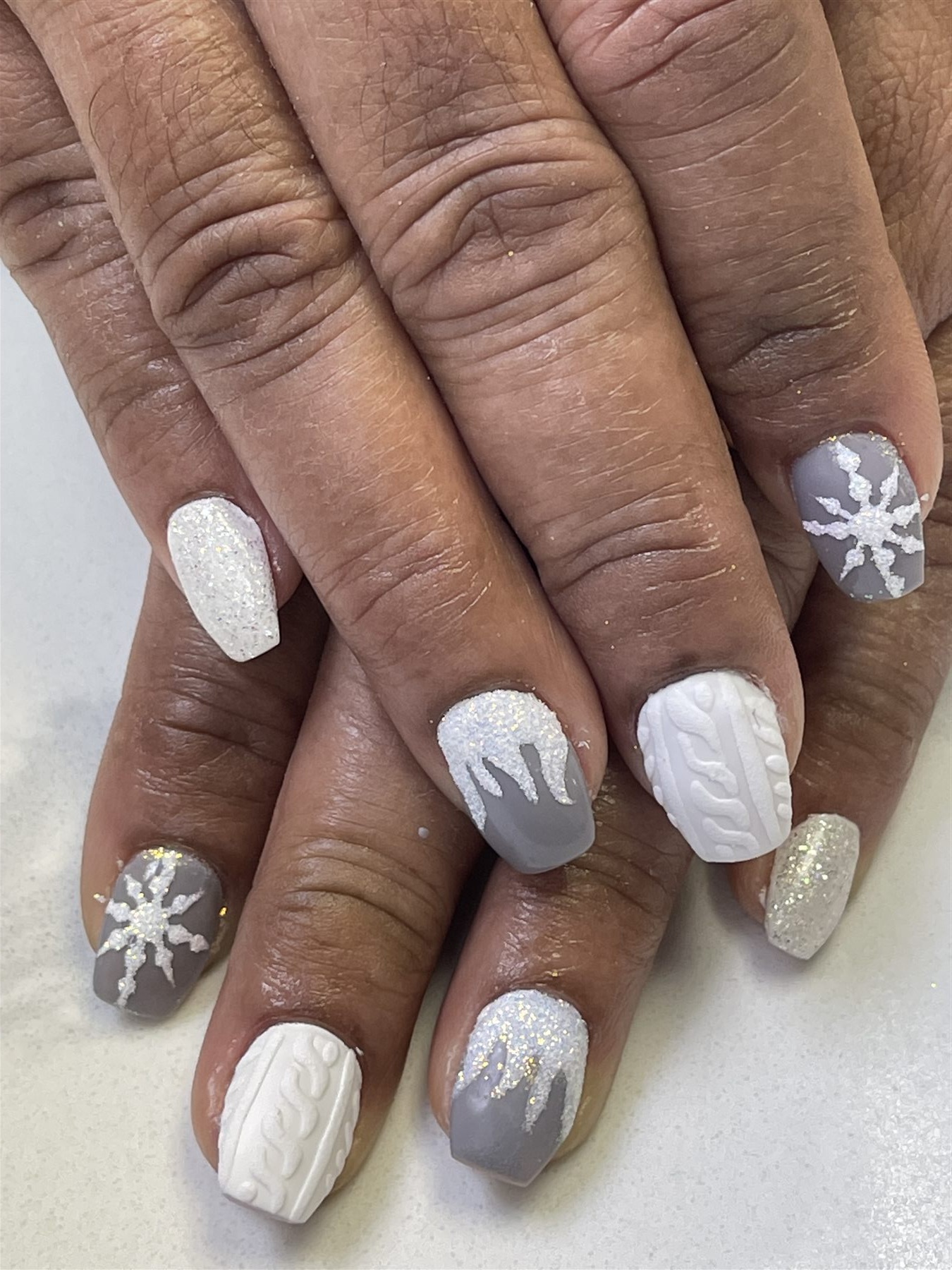 Grey white and glitter winter nails with snowflakes and knit texture