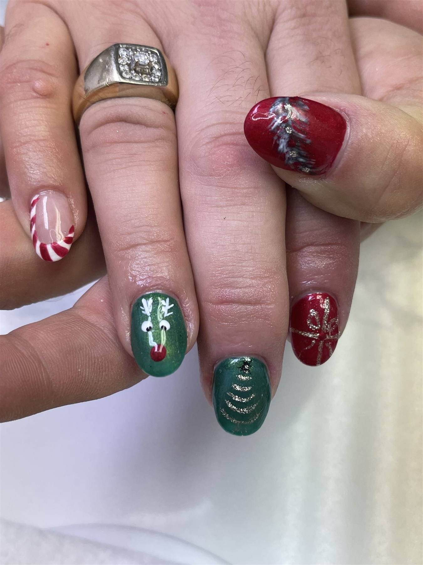 Red and green Christmas nails with reindeer candy cane gift and tree art