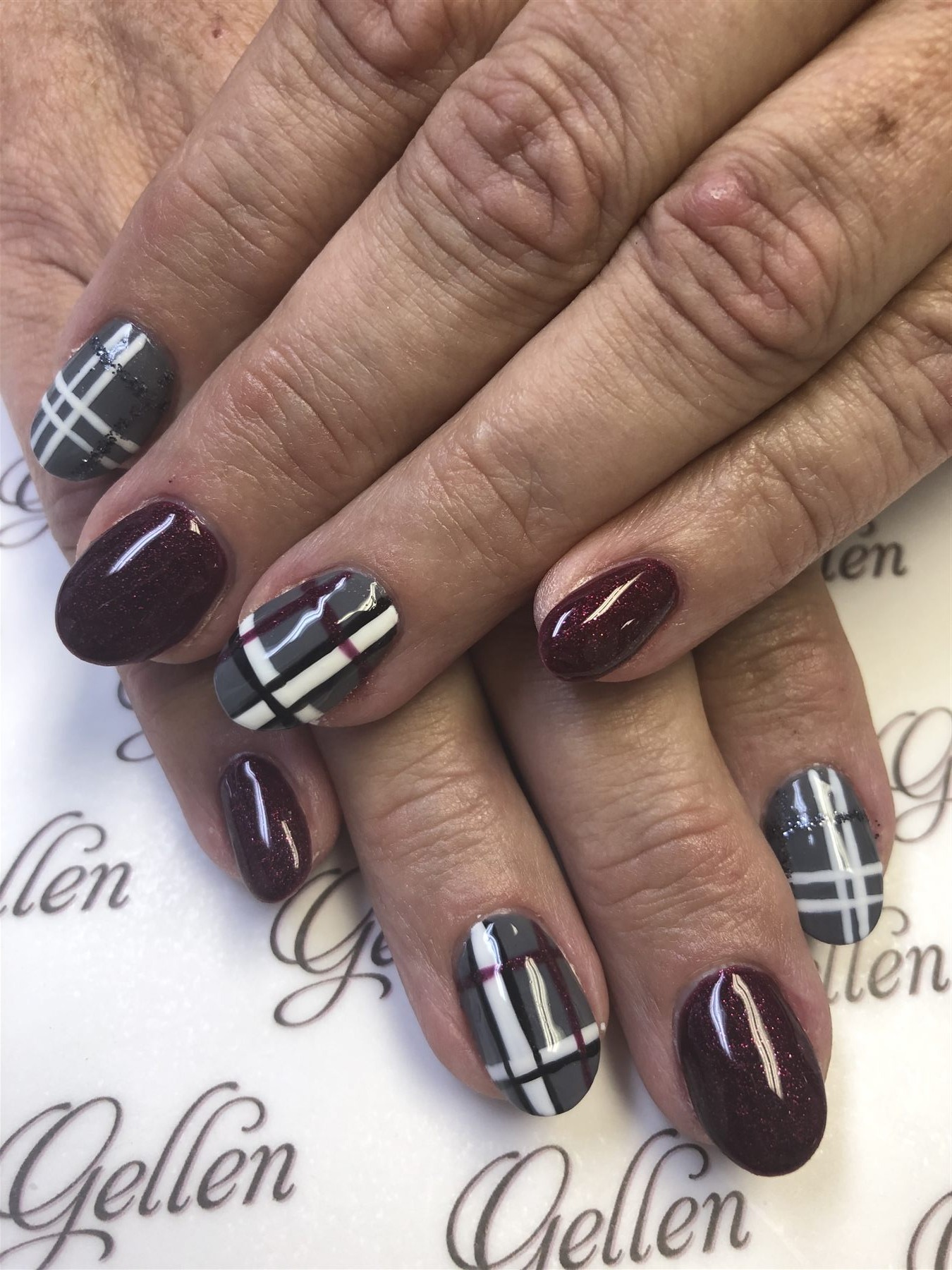 Burgundy glitter and grey plaid nail design