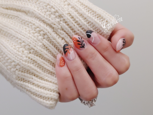 Terracotta blush and black botanical manicure styled with knitwear