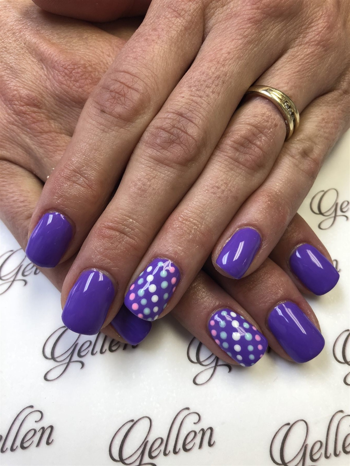 Purple nails with pastel dot accent art